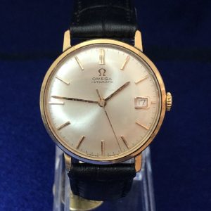 Reloj Omega vintage, de caballero, esfera de 34 mm, con fecha, en oro de ley 18 kts con pulsera de piel genuina, automático.